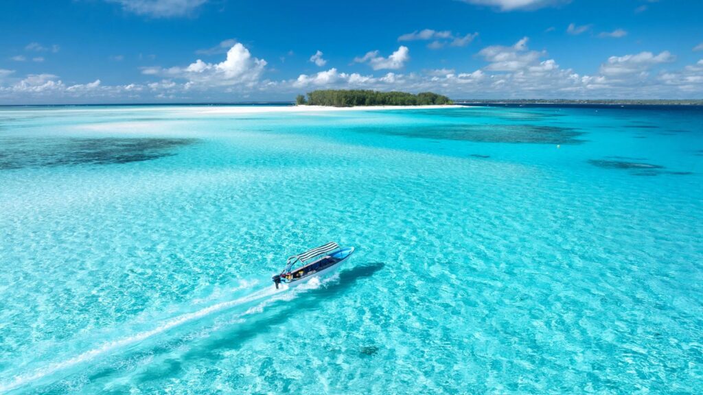 atolón de Mnemba. Agua de mar colo turquesa. embarcación. islote de arena blanca, vegetación